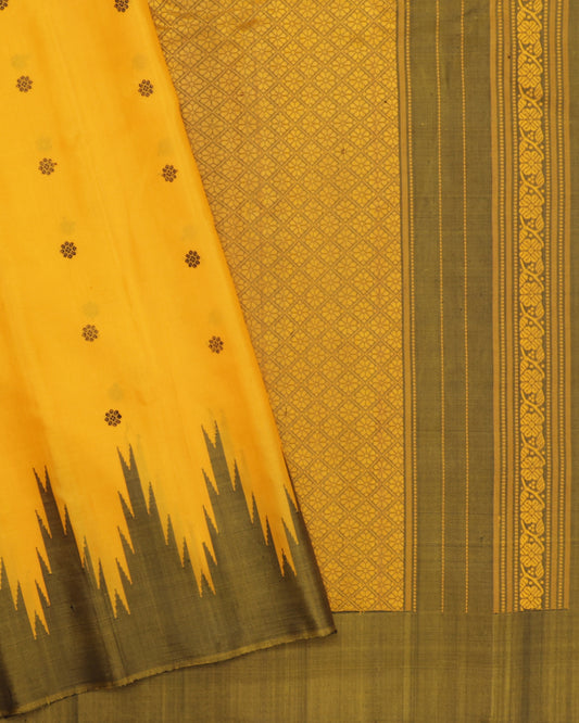 Mustard yellow Gadwal silk saree with olive green temple border and zari butas