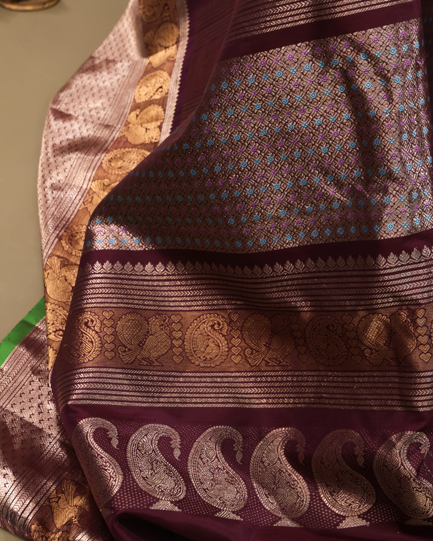Unstitched maroon blouse with zari buttas and double zari border, included with Gadwal silk saree