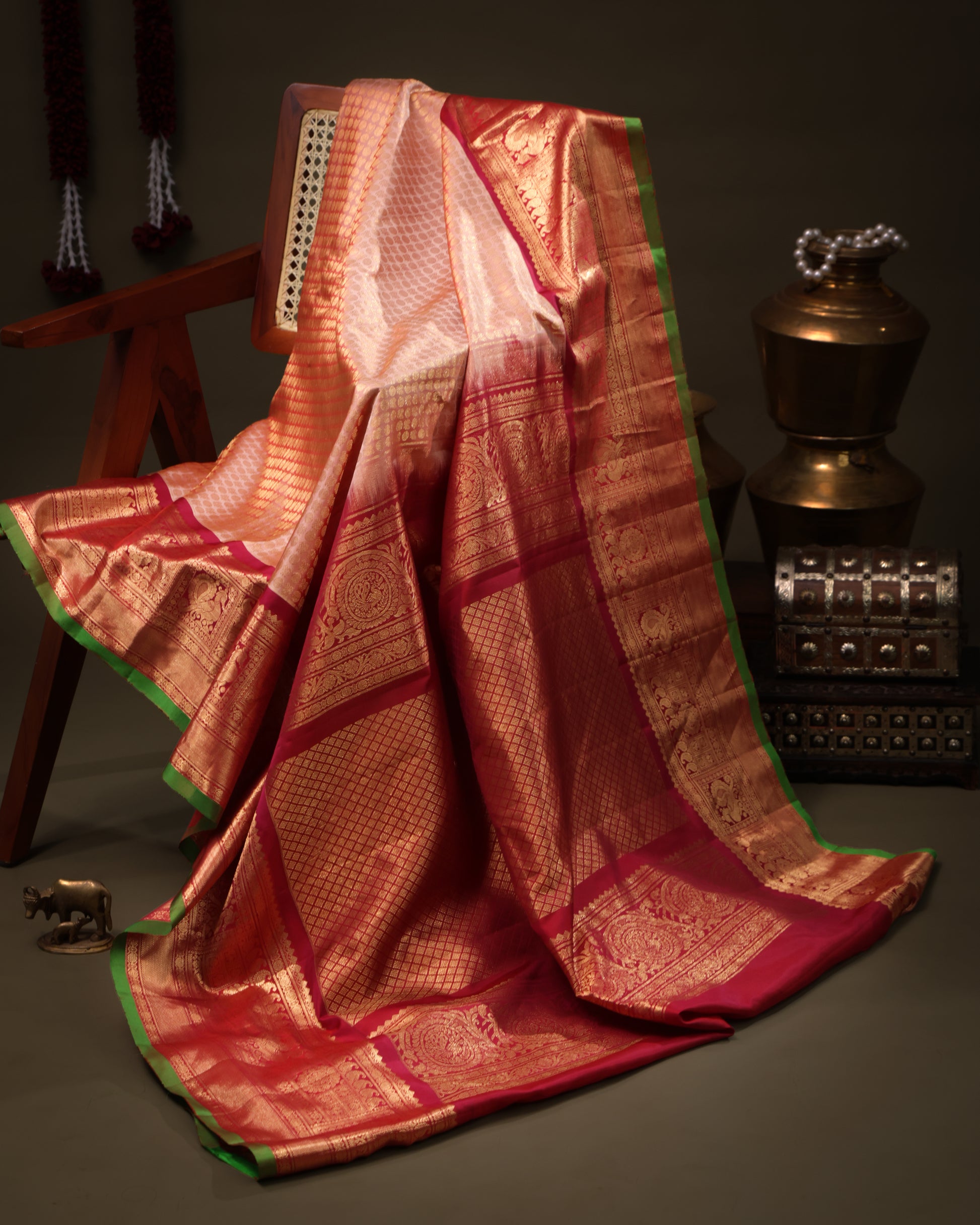 Peach saree with vermilion border featuring peacock motifs