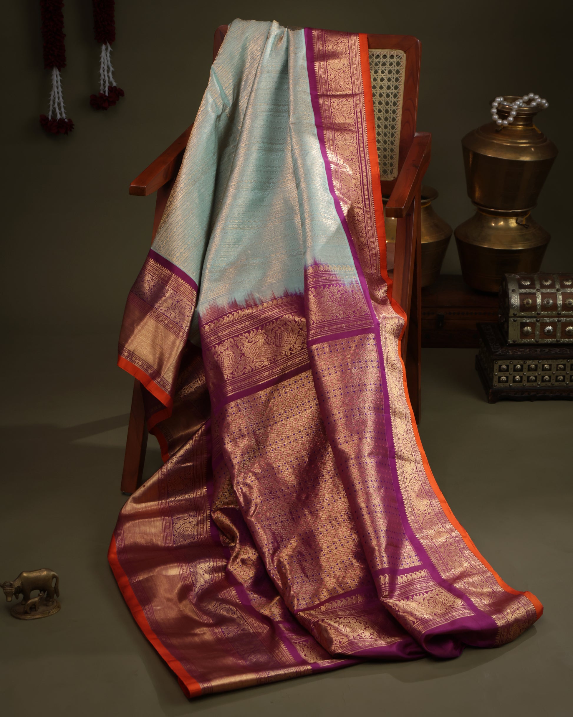Aqua blue saree with purple contrast Kanchi border and zari motifs