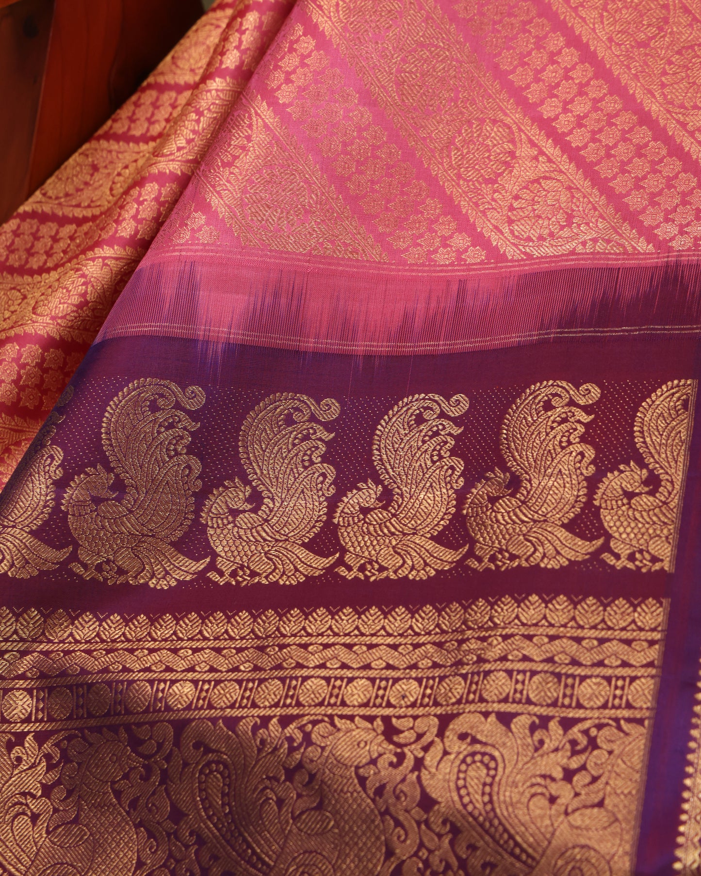 Pink saree with purple border and intricate zari pallu