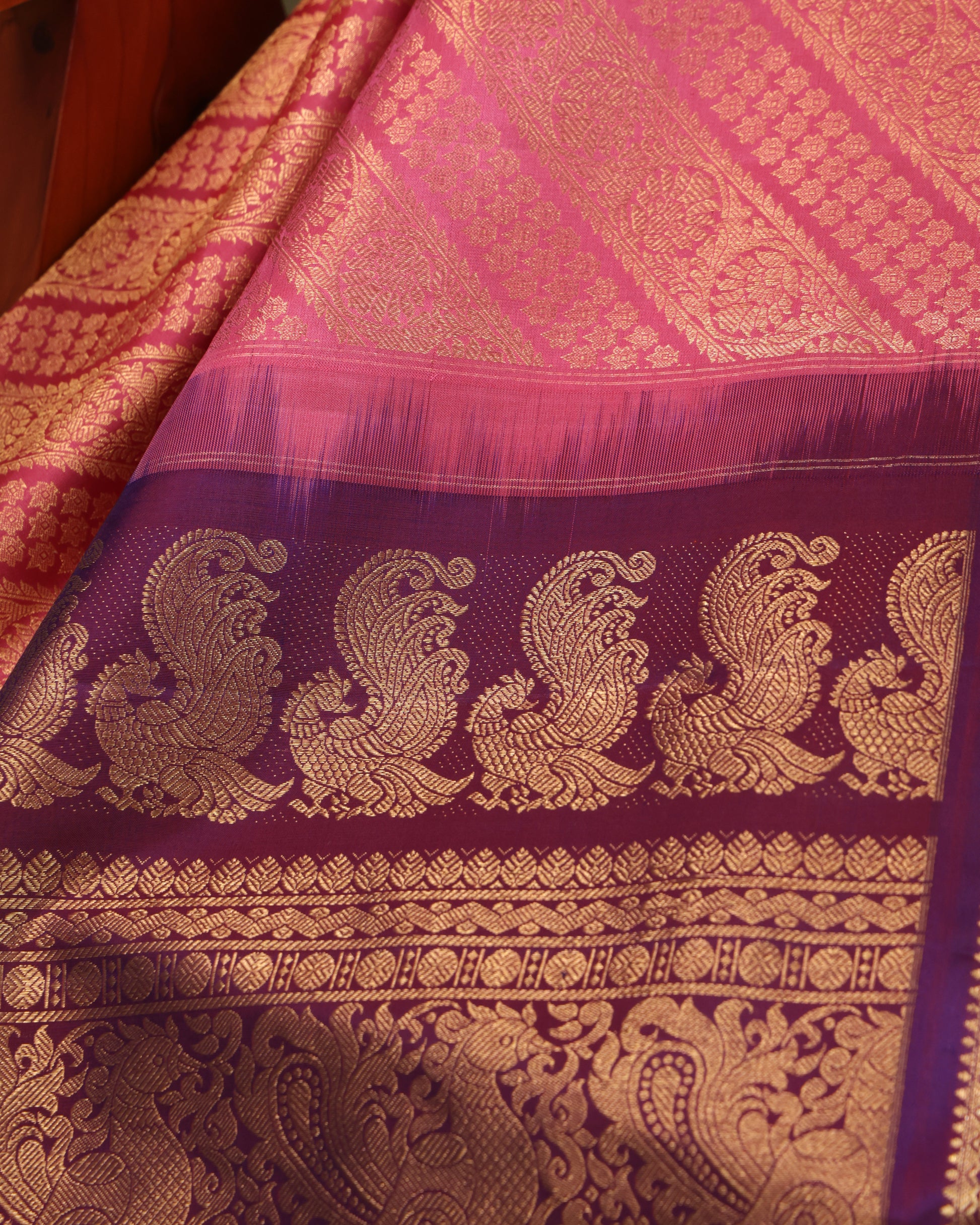 Pink saree with purple border and intricate zari pallu
