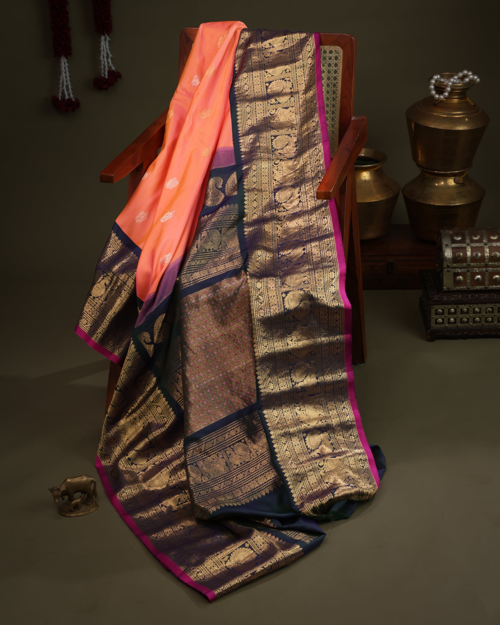 Coral saree with navy blue contrast border and pink selvedge