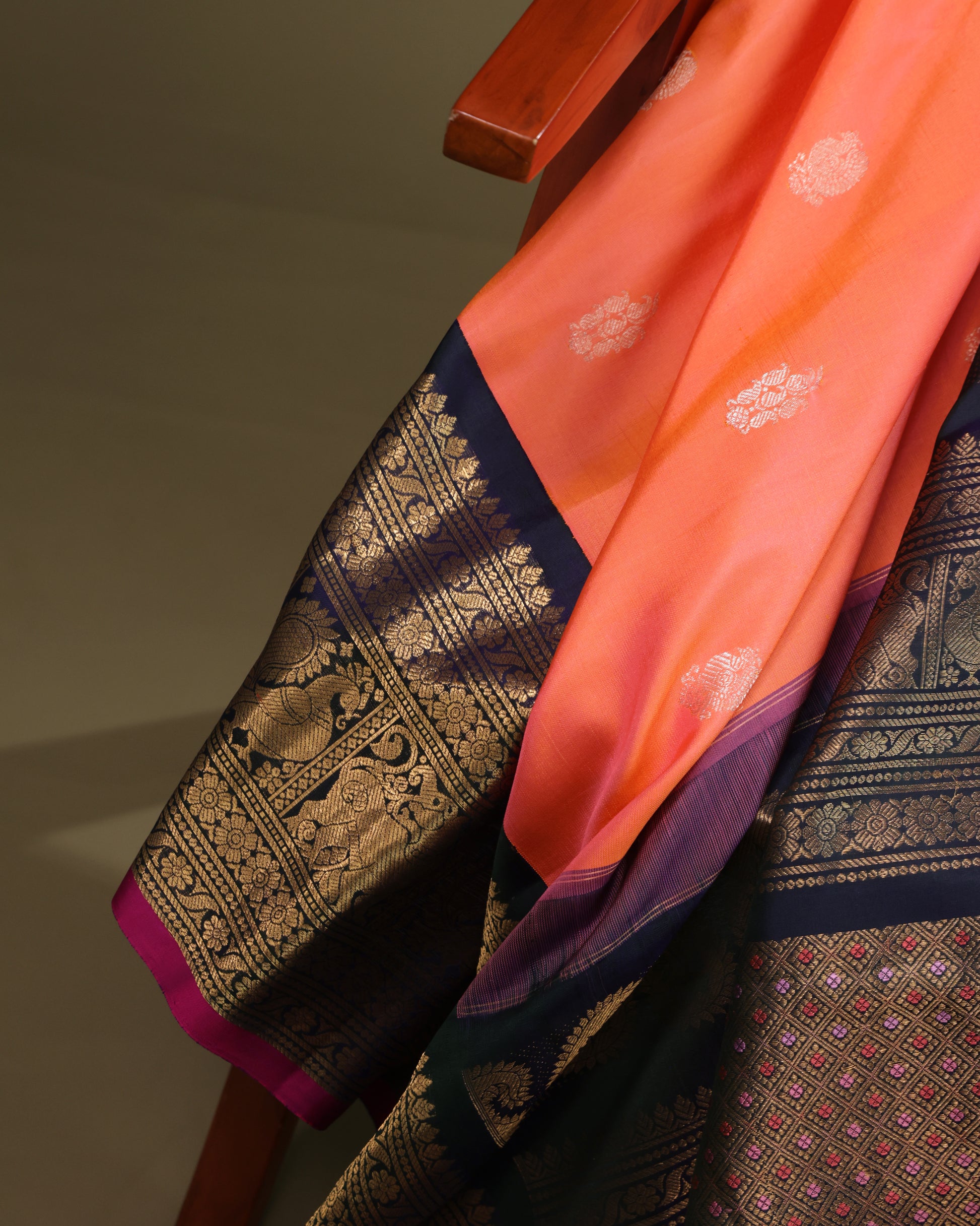 Festive coral silk saree with navy blue pallu and zari weaving