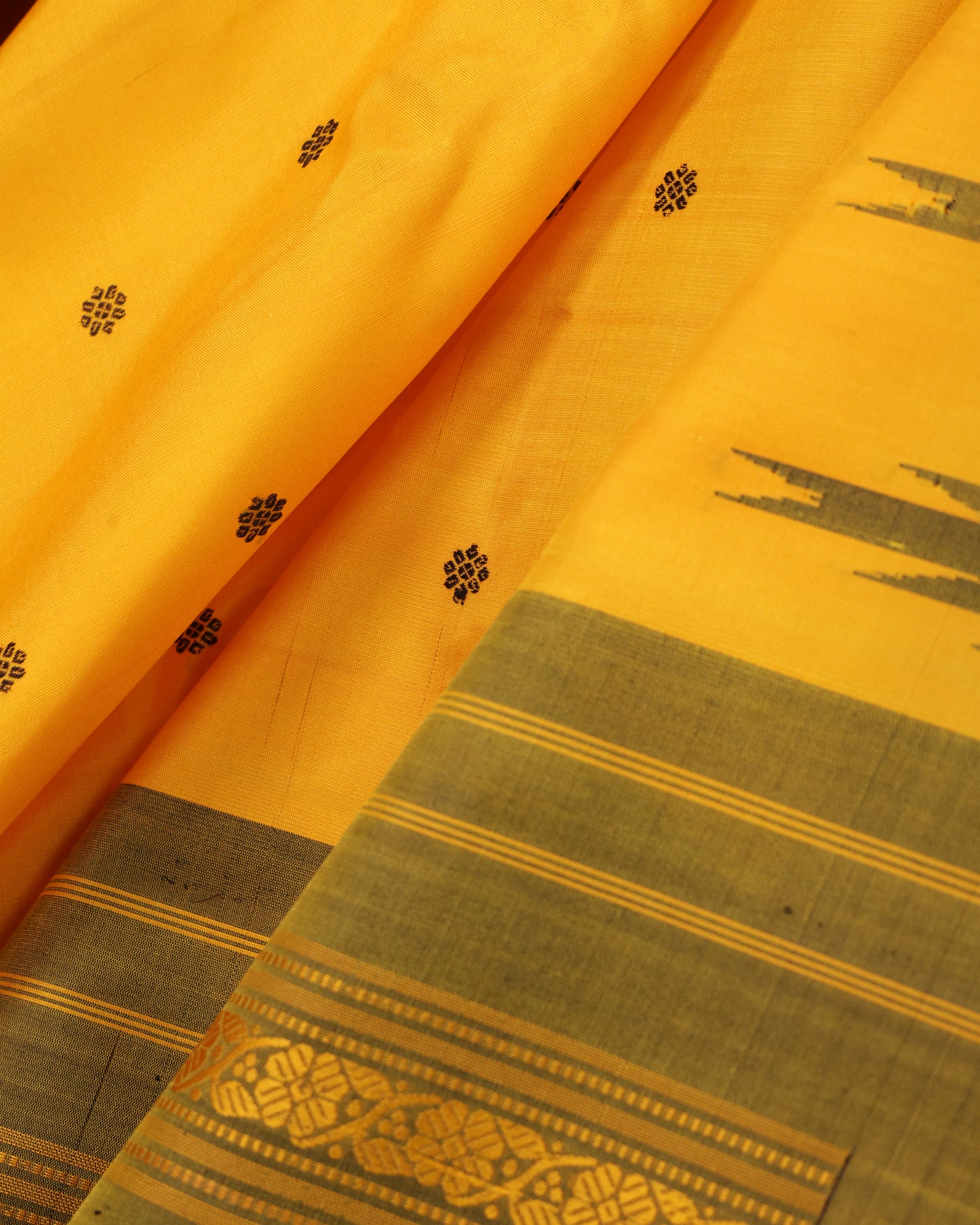 Mustard yellow Gadwal silk saree with olive green blouse and zari border