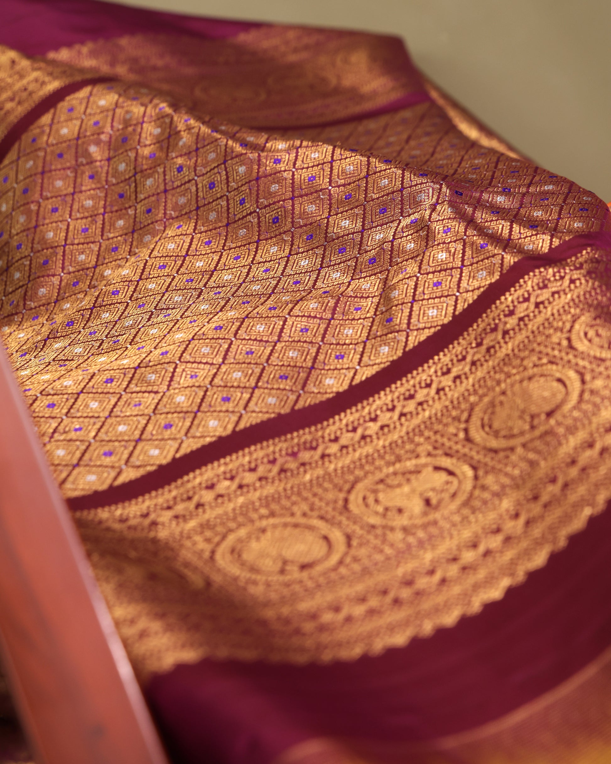 Purple unstitched blouse fabric with intricate gold zari border in traditional Gadwal Kanchi style