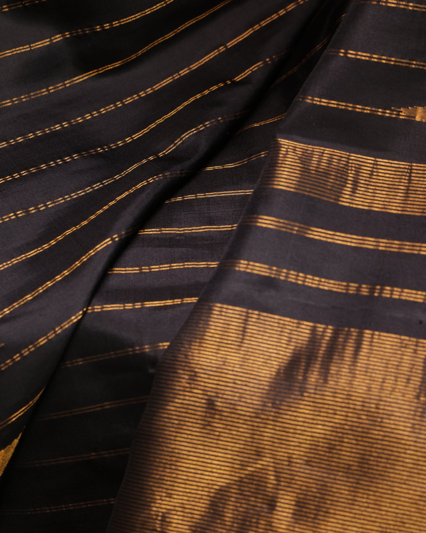 Black unstitched blouse with gold zari temple border, paired with the Gadwal silk saree