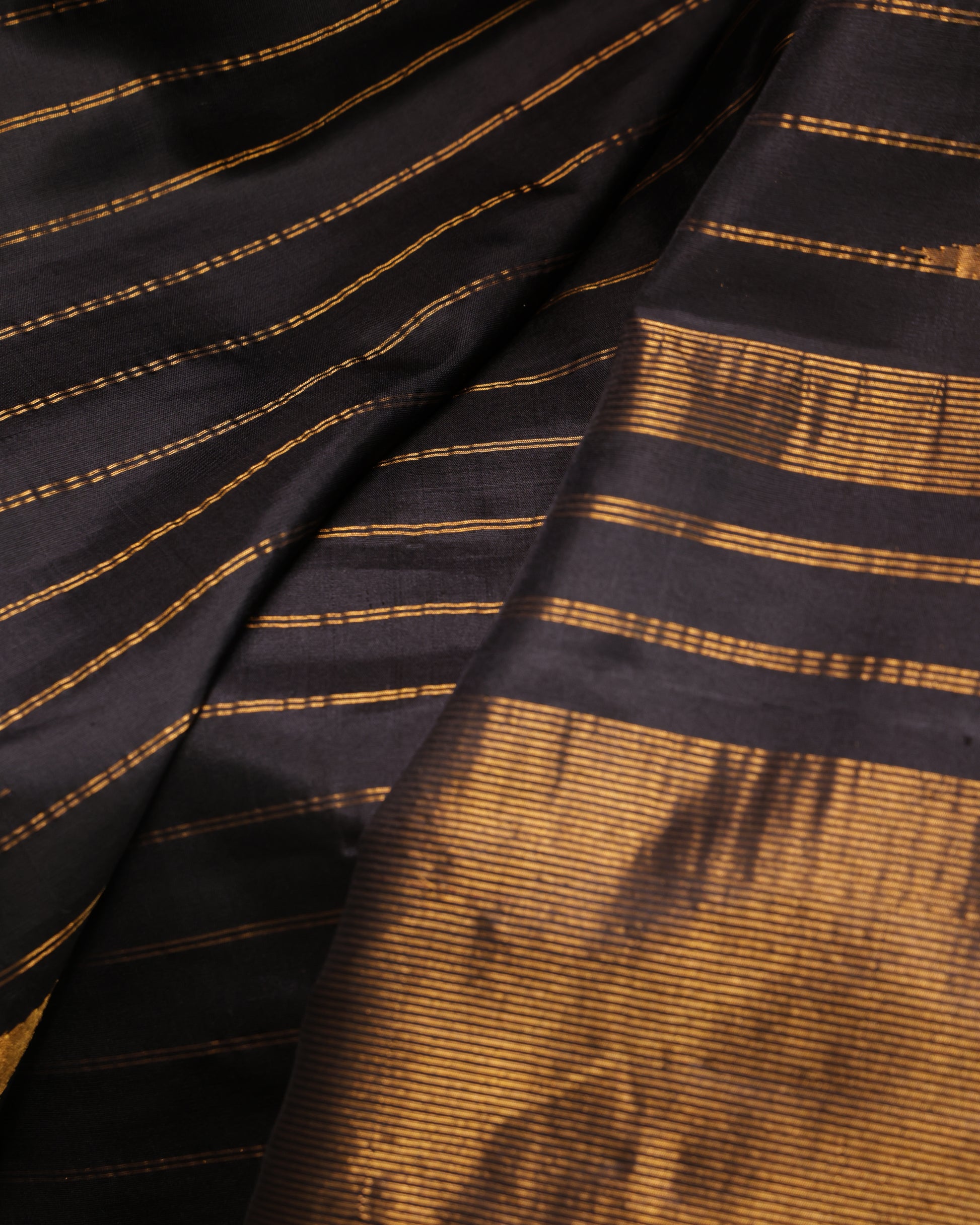 Black unstitched blouse with gold zari temple border, paired with the Gadwal silk saree