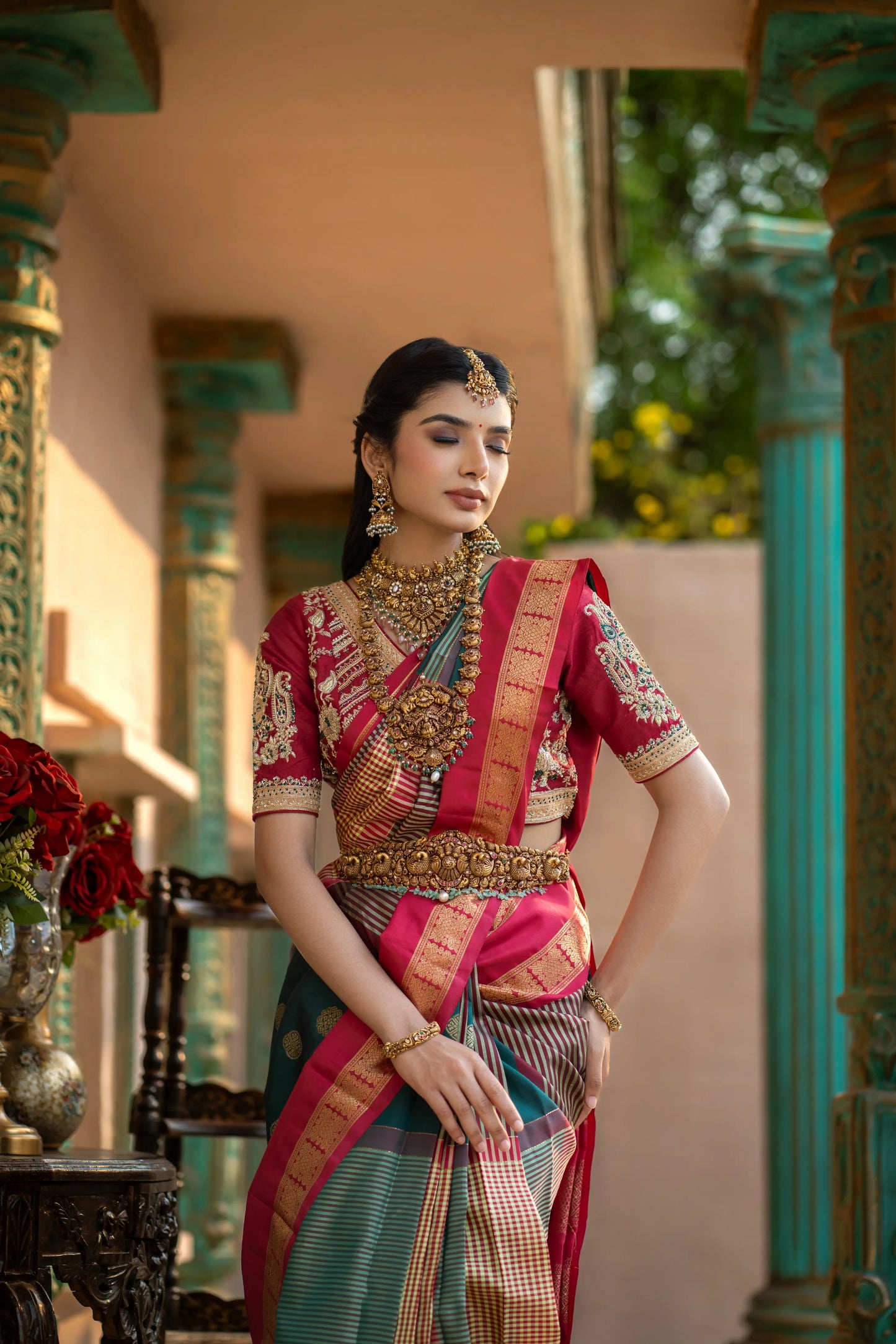 Traditional Kanjivaram saree in green and red with woven motifs and temple borders