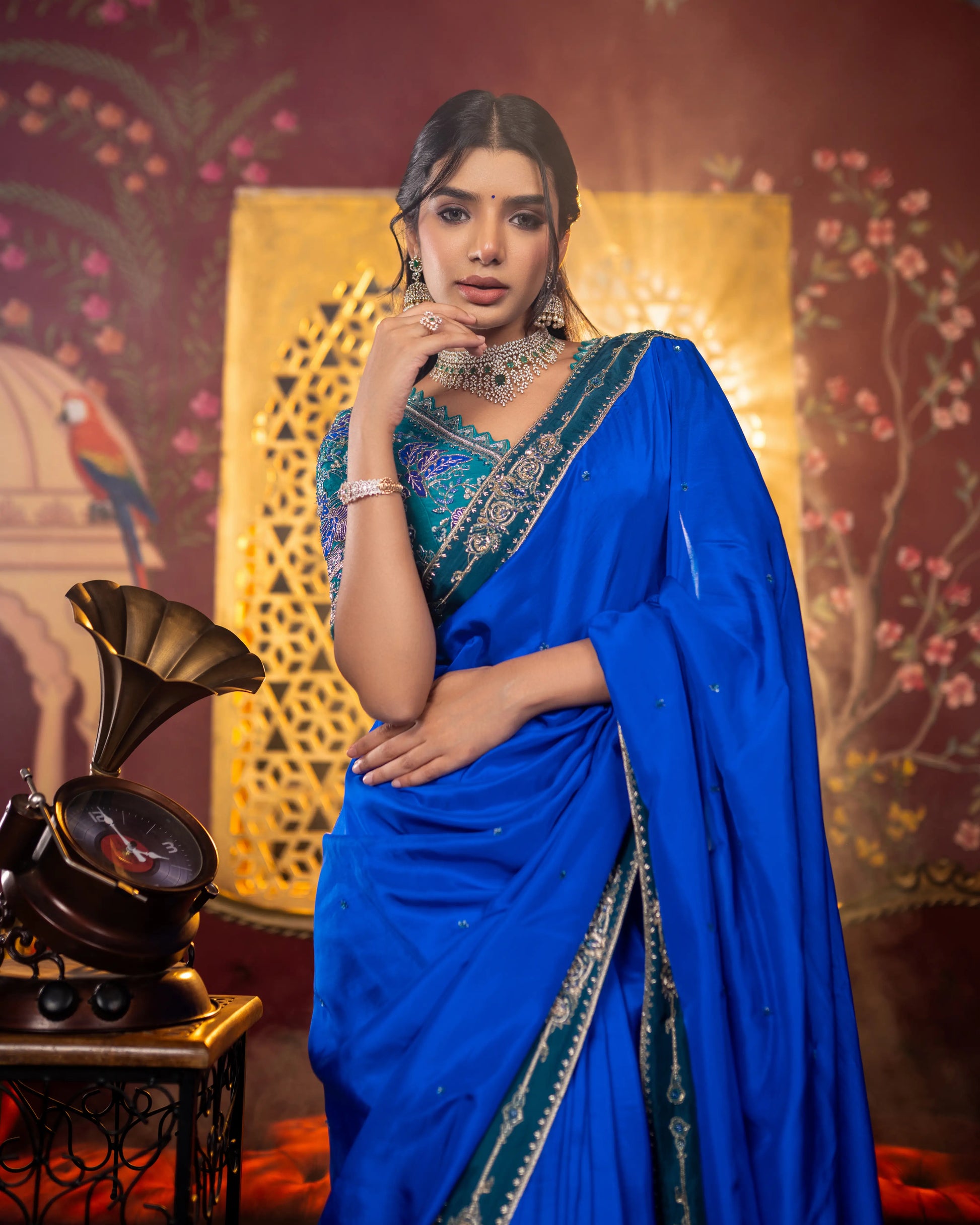 Royal blue saree with contrast green border and delicate embellishments