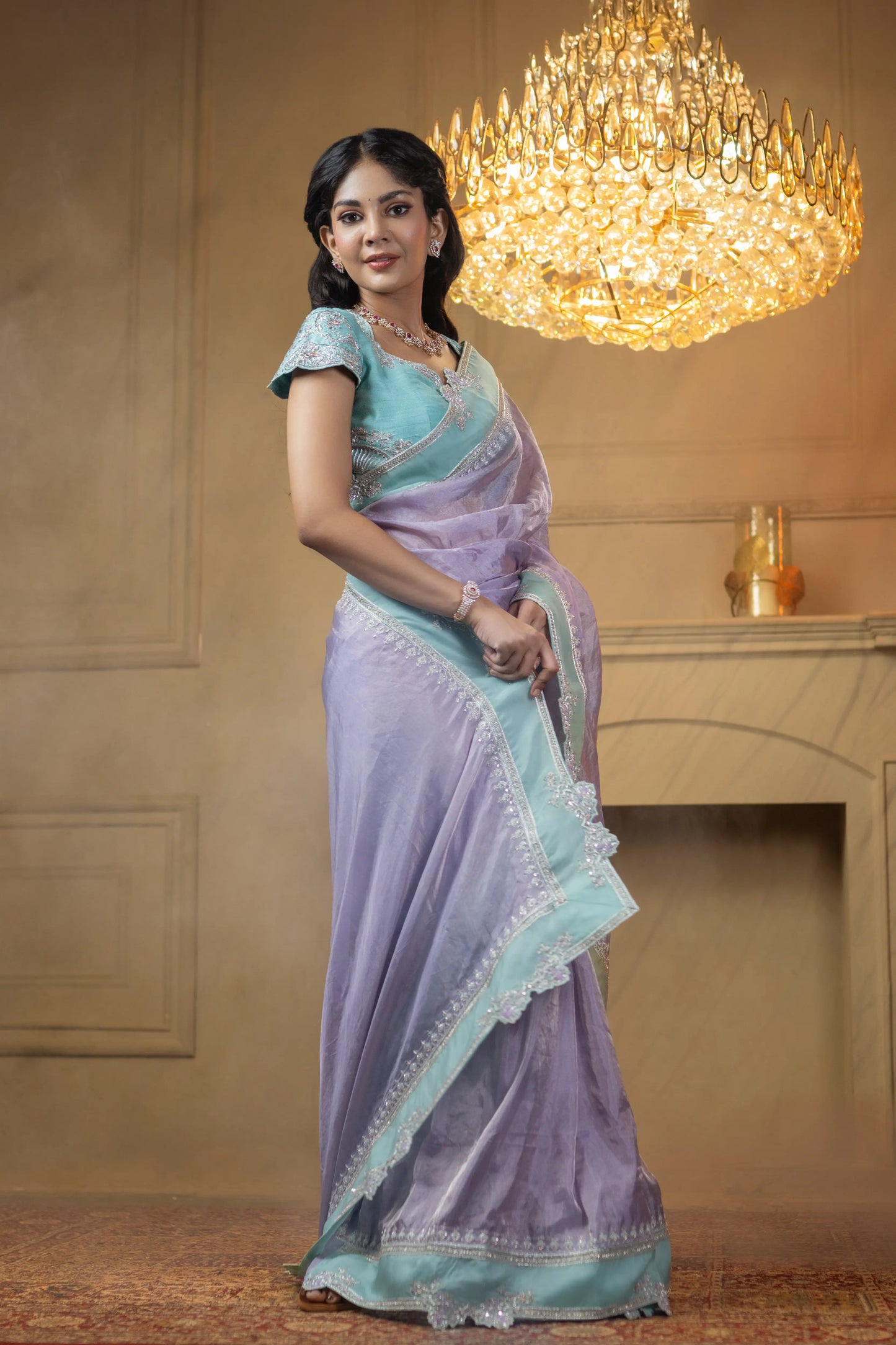 Elegant lavender saree with contrast aqua handwork border and shimmer finish