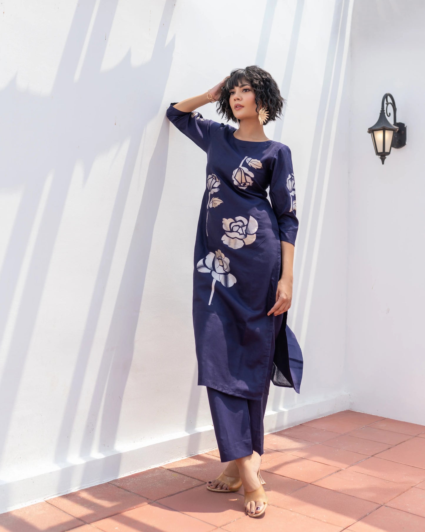 Elegant ethnic outfit in navy blue with Banarasi floral accents – perfect for poojas and celebrations