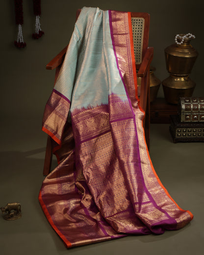 Aqua blue saree with purple contrast Kanchi border and zari motifs