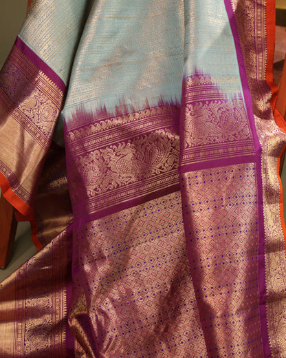 Festive aqua blue Gadwal silk saree with purple and orange contrast 