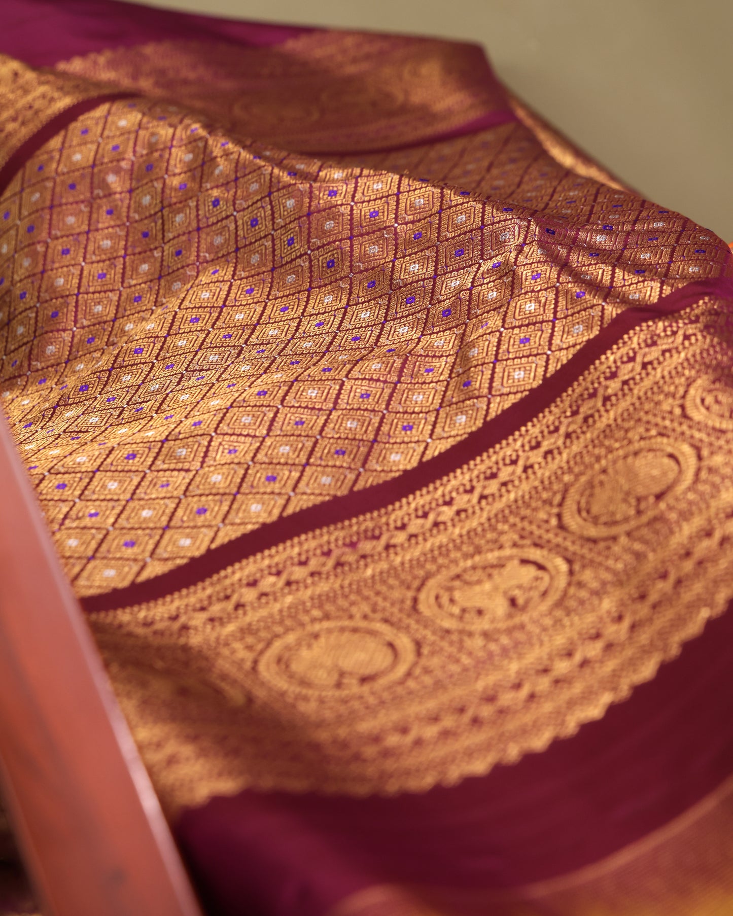 Purple unstitched blouse fabric with intricate gold zari border in traditional Gadwal Kanchi style